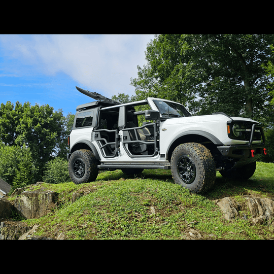 Ford Bronco with black soft-top roof rack system; flip-top panels open to sides showcasing easy access and versatile design.