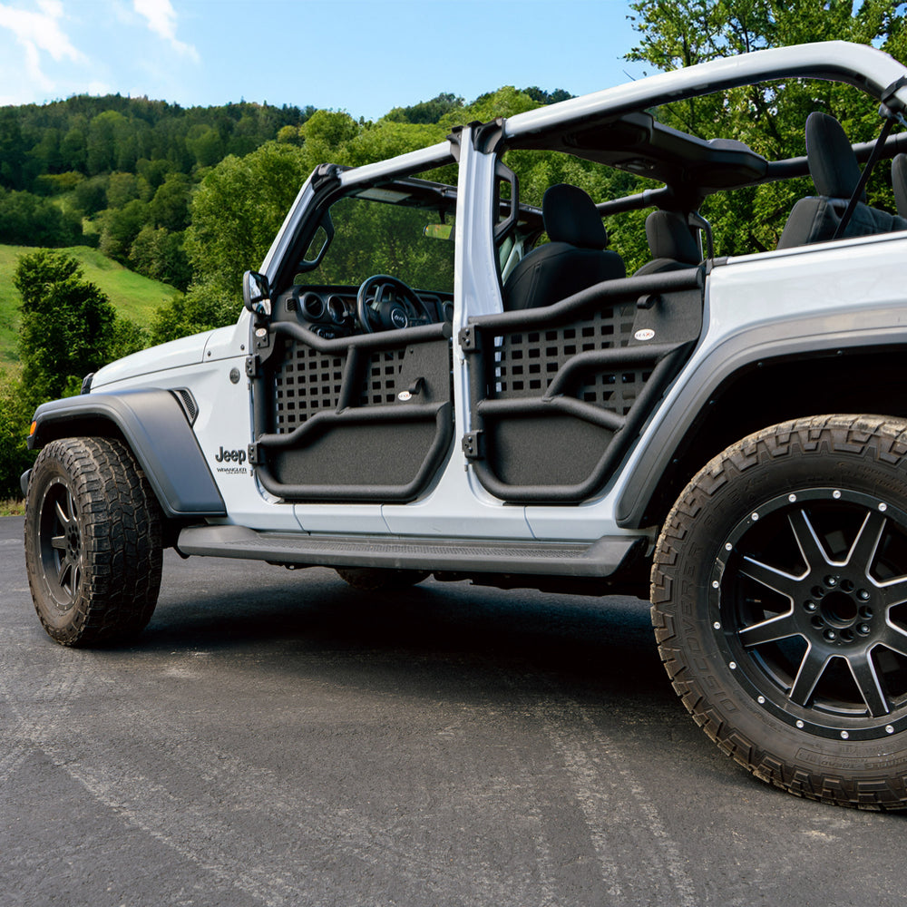White 4-door Jeep with Alpha tube doors and all-weather panels for durable, weather-resistant off-road protection.