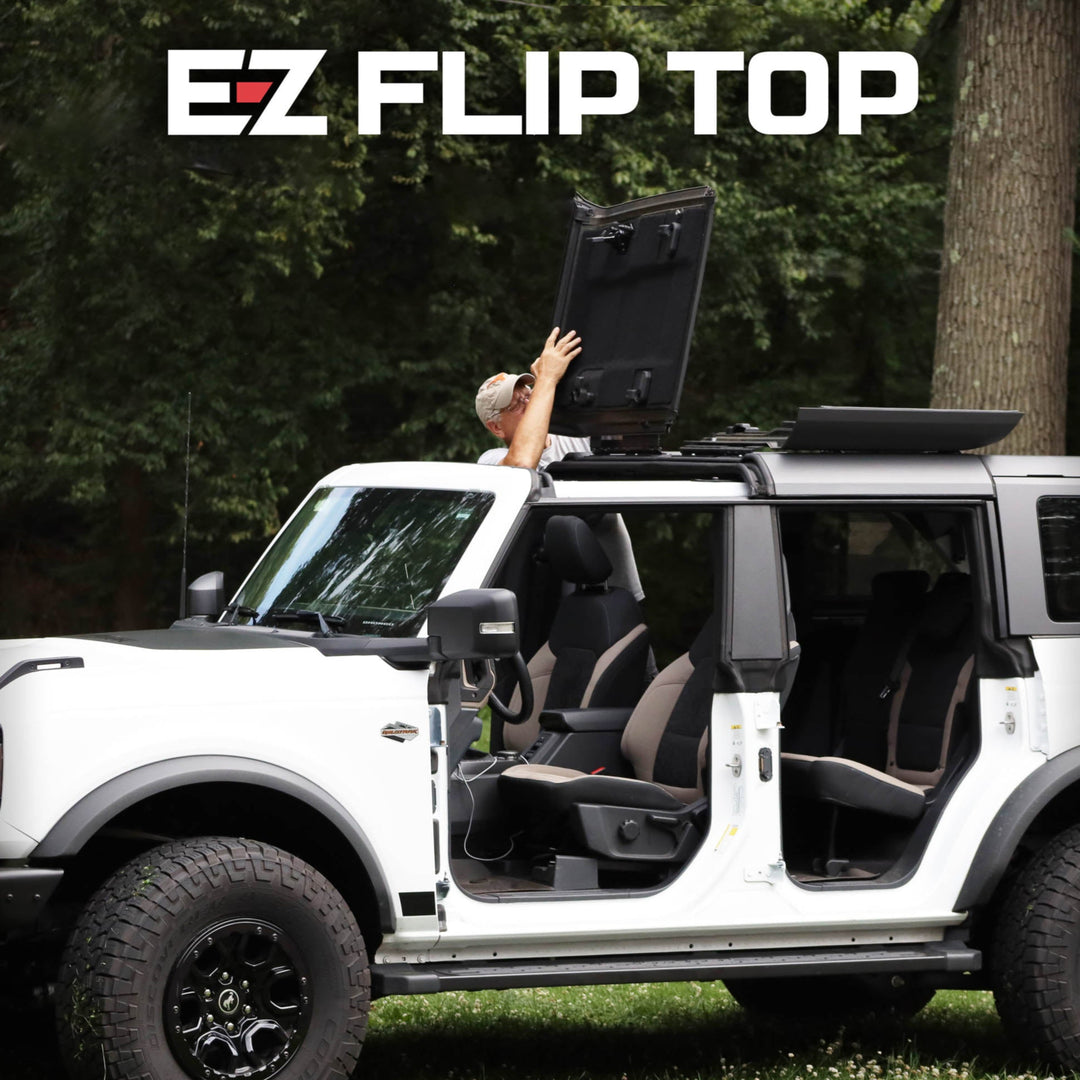 White SUV with EZ Flip-Top panels open in nature, showing branded roof system for easy ventilation and outdoor adventure.