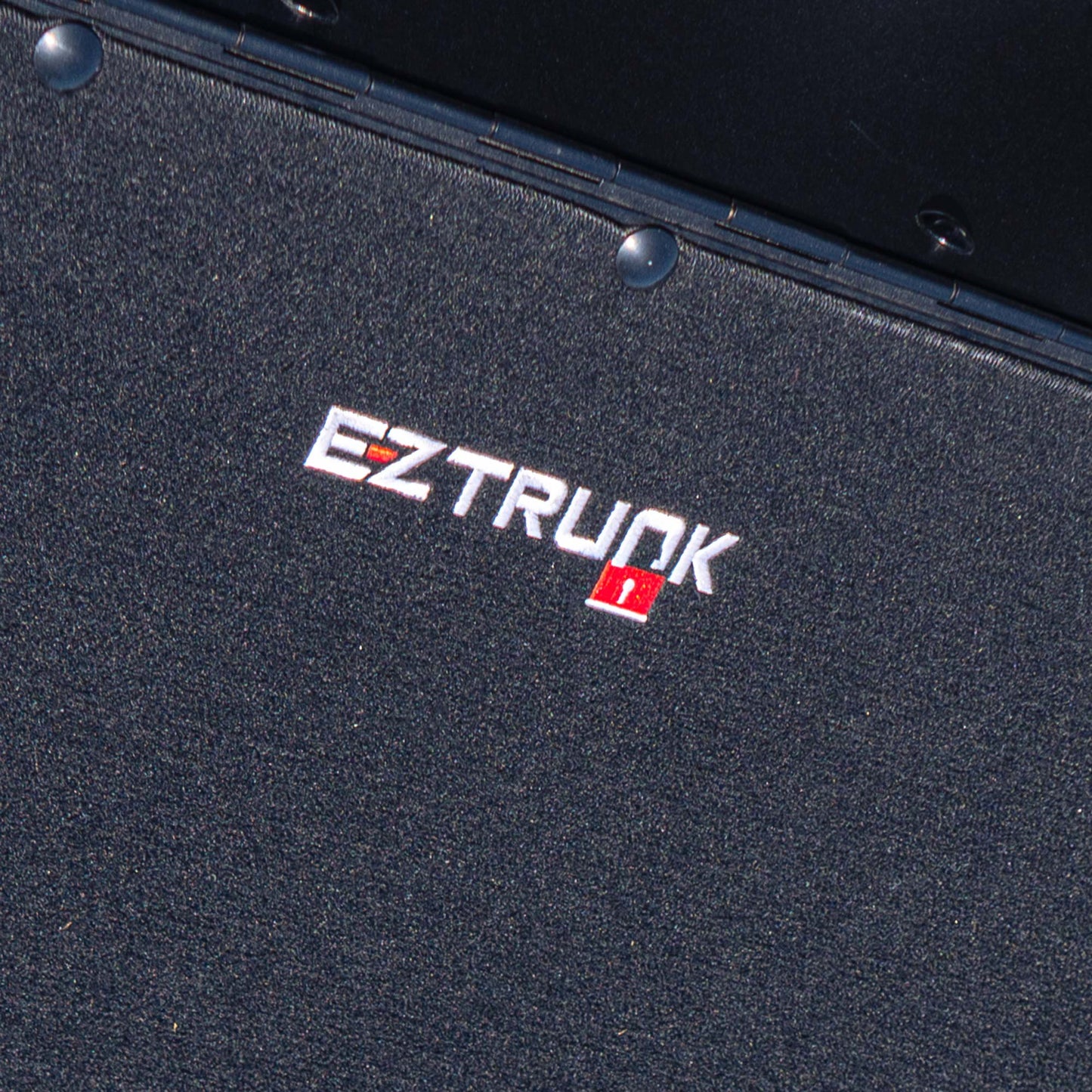 Close-up of custom-fit carpet texture showing dense weave and durable material for vehicle interior protection.