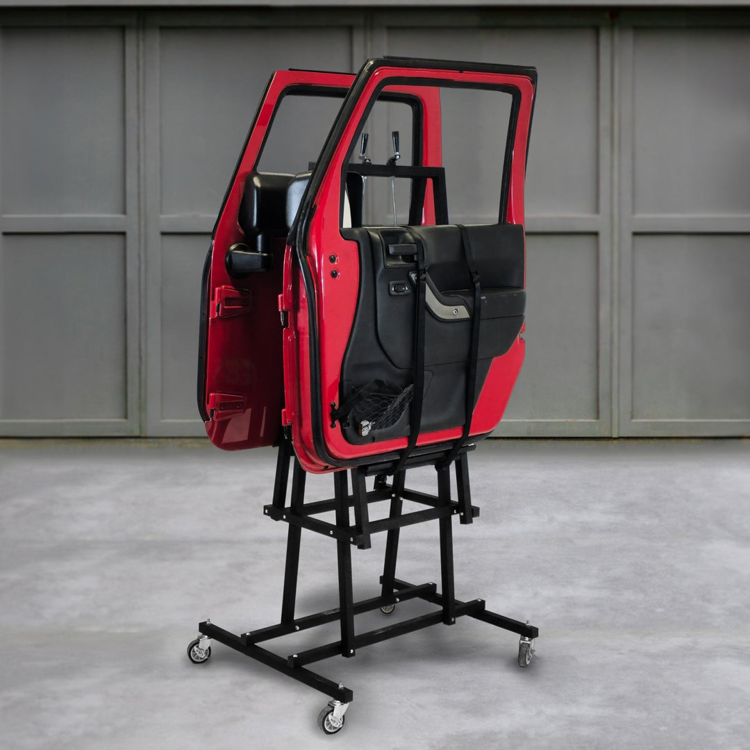 Angled view of EZ4X4 EZ Door Lift securing red Jeep doors, with garage in background, showing safe vertical door storage.