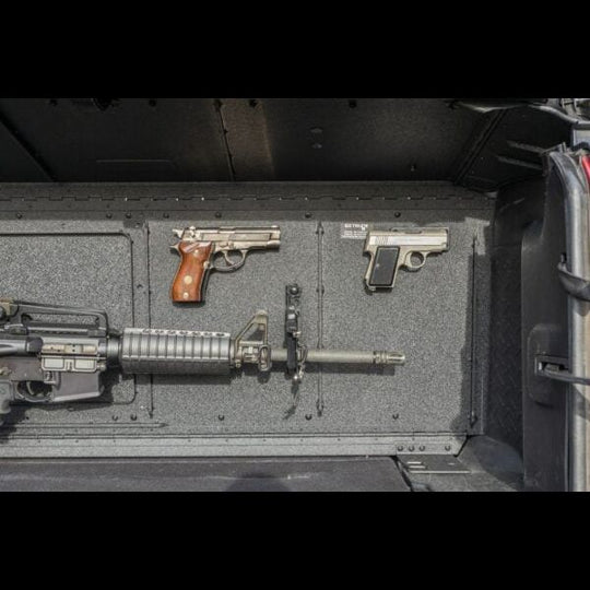 Magnetic gun holder securing firearms in Jeep trunk, showcasing safe storage for off-road or travel use.