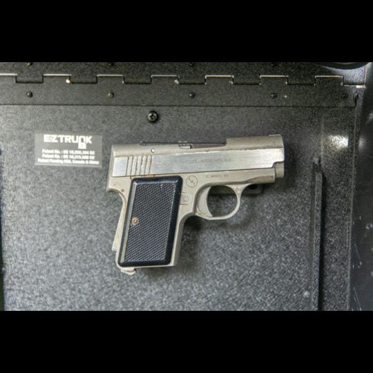 Magnetic gun holder securing a gun in EZ trunk, showcasing safe, durable, and discreet storage for off-road or travel use.