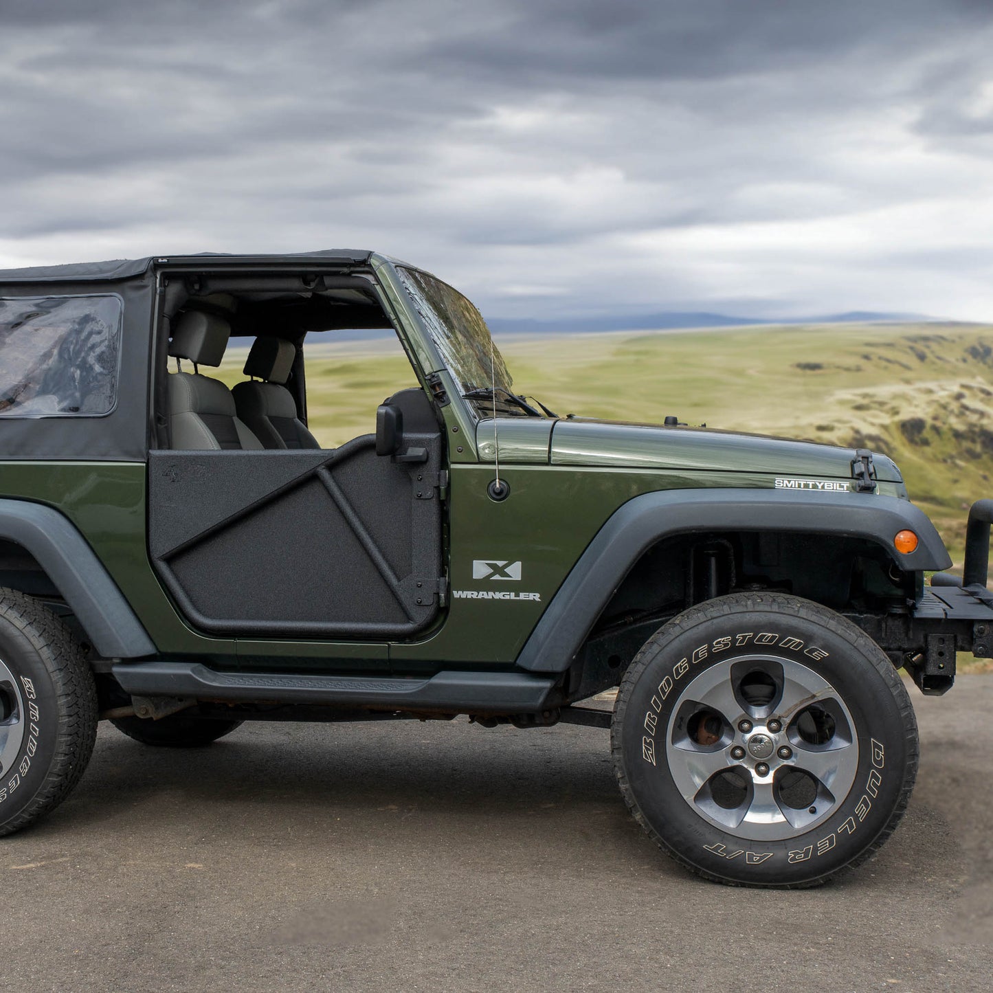 Photo 2: Green Jeep with black Phantom aluminum doors and panels, showing rugged off-road protection and custom style.