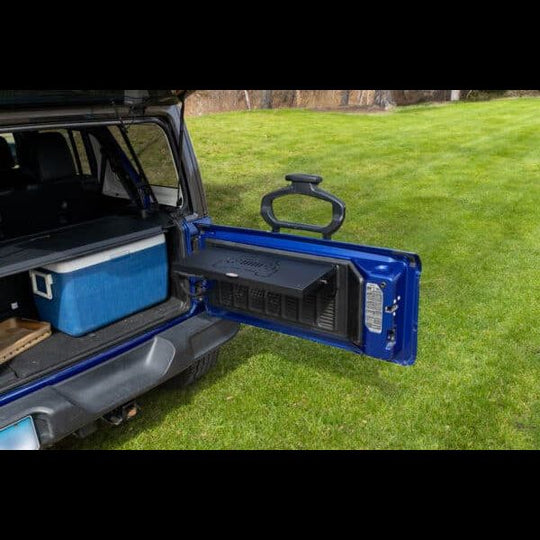 Foldable cargo shelf rack on blue Jeep Wrangler tailgate—portable, space-saving design for overlanding and tailgating.