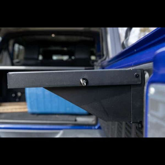 Close-up of key ring on black foldable Jeep tailgate table, highlighting sturdy design, utility, and space-saving storage.