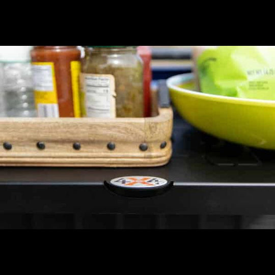 Second close-up of food arranged on black Jeep tailgate shelf, showing sturdy design perfect for camping and outdoor meals.