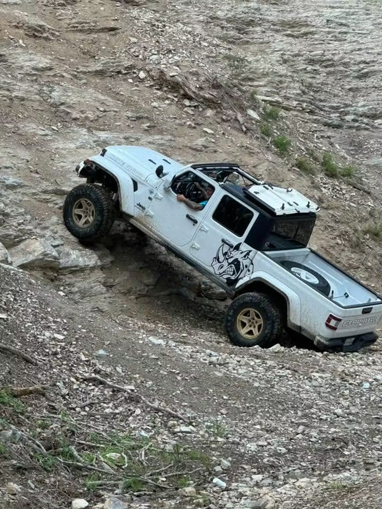 White Jeep JT Gladiator climbing a steep, rocky trail with the EZ4X4 EZ FlipTop during extreme off-road use.
