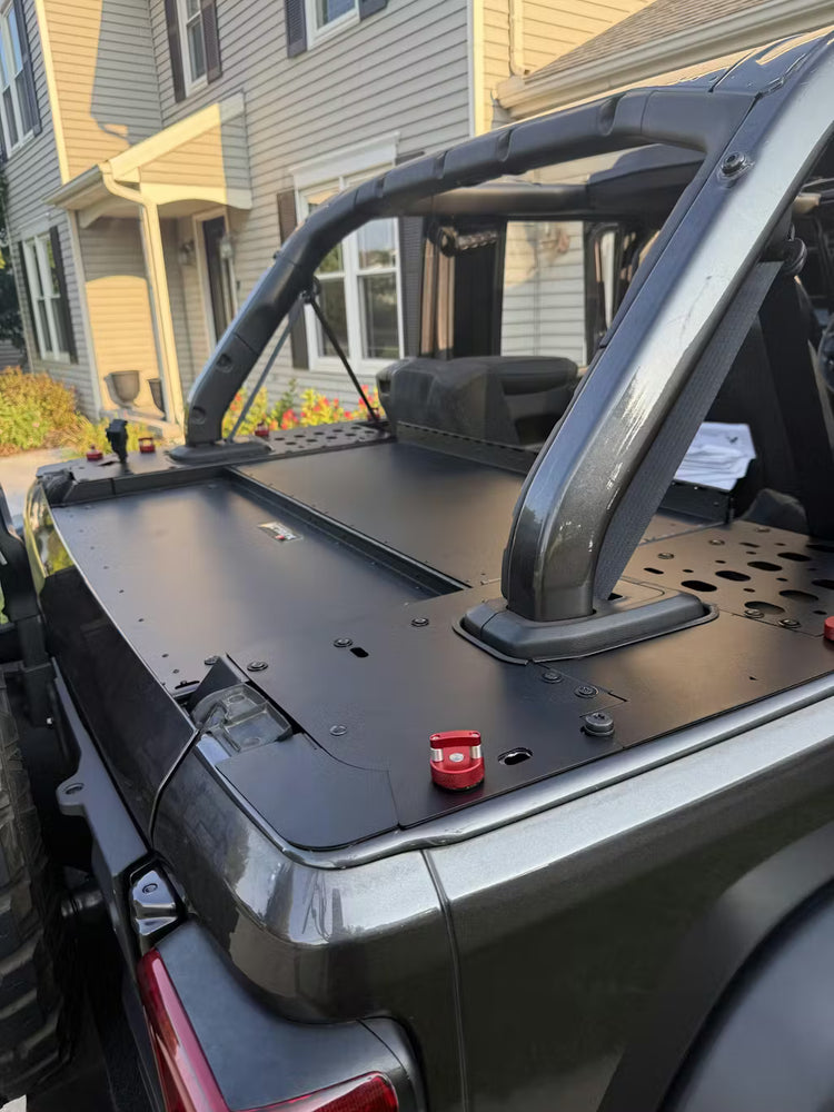 EZ4X4 Extreme EZTRUNK system installed in the trunk of a green four-door Ford Bronco parked in a residential area.