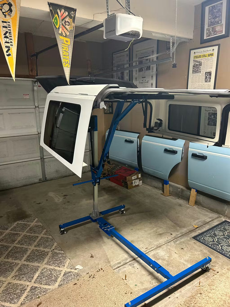 EZ4X4 Hard Top Remover Lift storing a white Ford Bronco hard top in a garage.