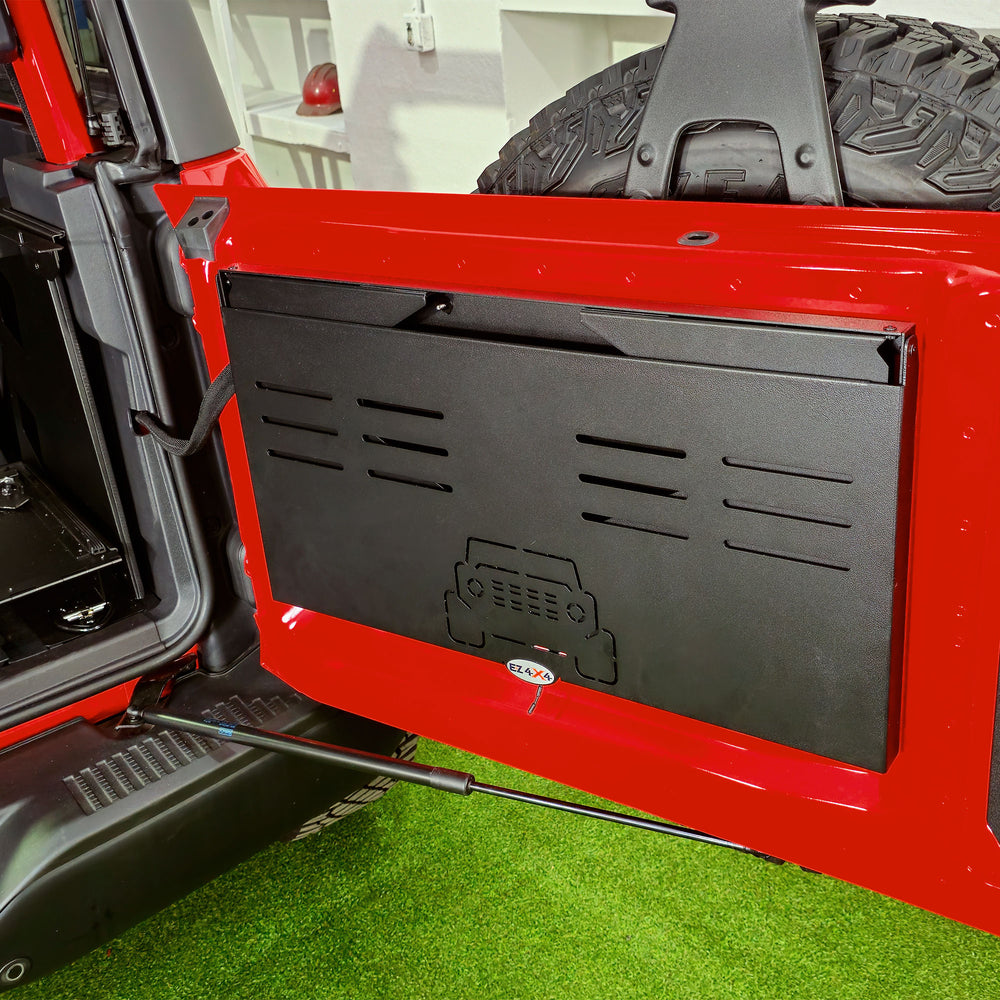 EZ4X4 Extreme Tailgate Table folded compactly and installed on the tailgate of a red Ford Bronco.