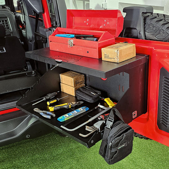 Fully opened EZ4X4 Extreme Tailgate Table on a Bronco, showcasing its ability to securely hold gear on both the top shelf and the second shelf.