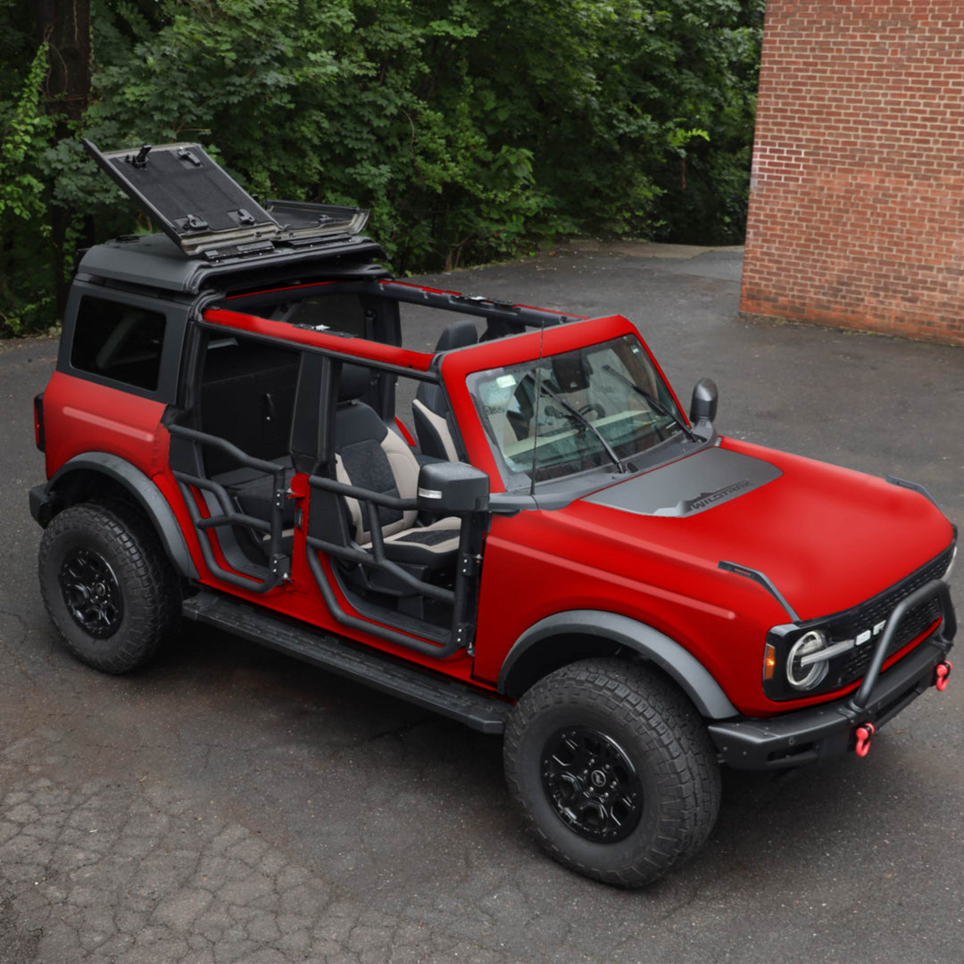 Red Ford Bronco equipped with EZ4X4 Alpha Tube Doors, an EZ FlipTop, and a Middle Panel Roof Rack Holder.