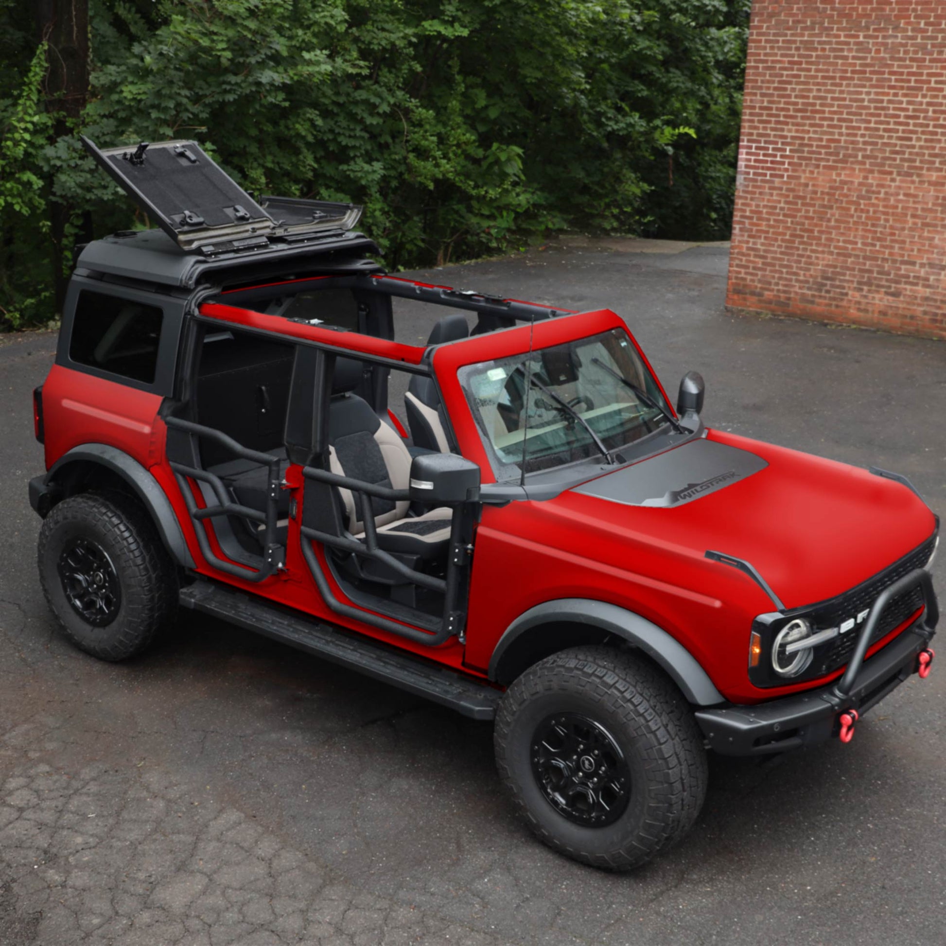 Red Ford Bronco equipped with EZ4X4 Alpha Tube Doors, an EZ FlipTop, and a Middle Panel Roof Rack Holder.