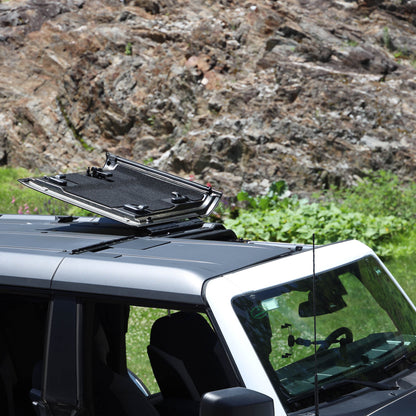 White Ford Bronco with flip-top panels fully open, showing roof flipped up for ventilation and off-road driving.