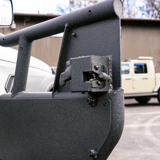 Close-up of the locking mechanism on the black EZ4X4 Alpha Tube Doors, showing the integrated latch hardware and powder-coated finish.