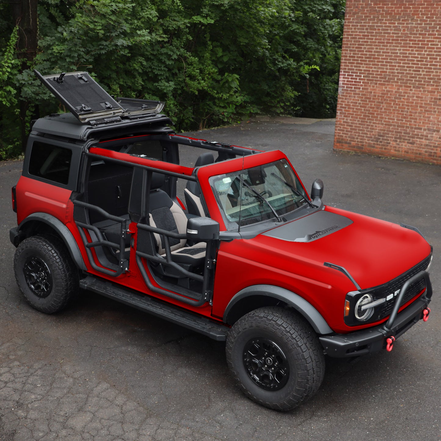 Red Ford Bronco with black aluminum Alpha doors installed, highlighting stylish design for enhanced off-road performance.