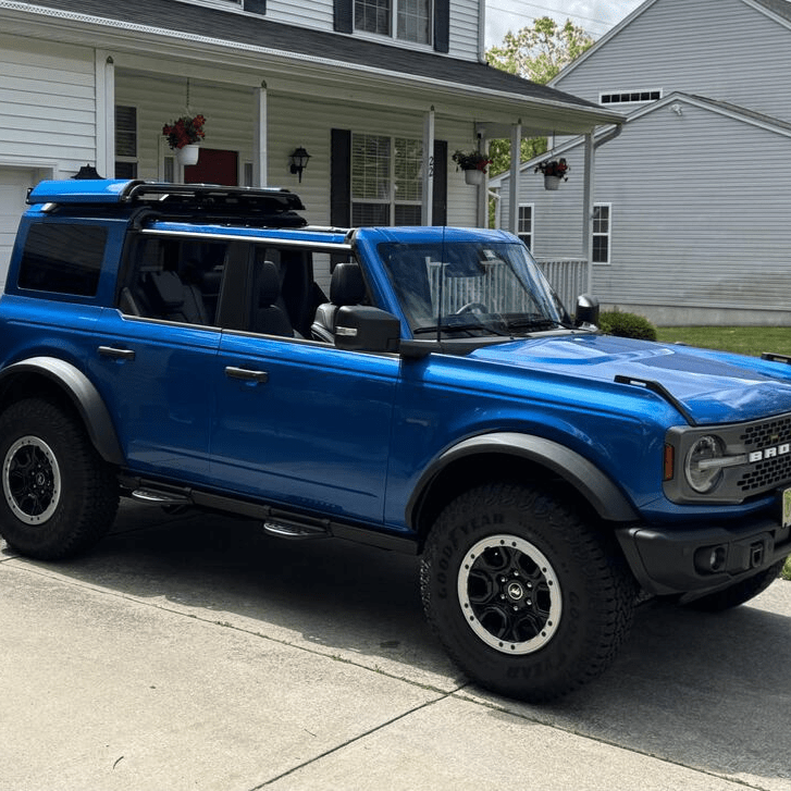 Close-up of customer-installed red Ford Bronco with EZ4X4 FlipTop and roof rack, showing rugged off-road functionality.
