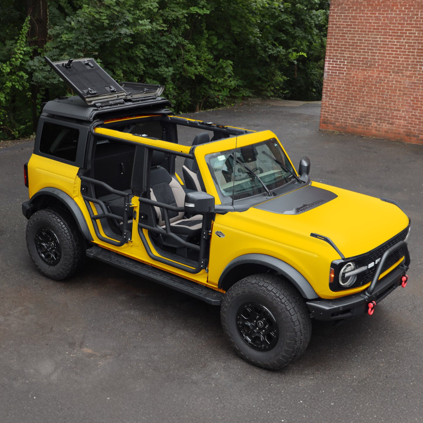 Yellow Ford Bronco equipped with EZ4X4 Alpha Tube Doors, an EZ FlipTop, and a Middle Panel Roof Rack Holder.