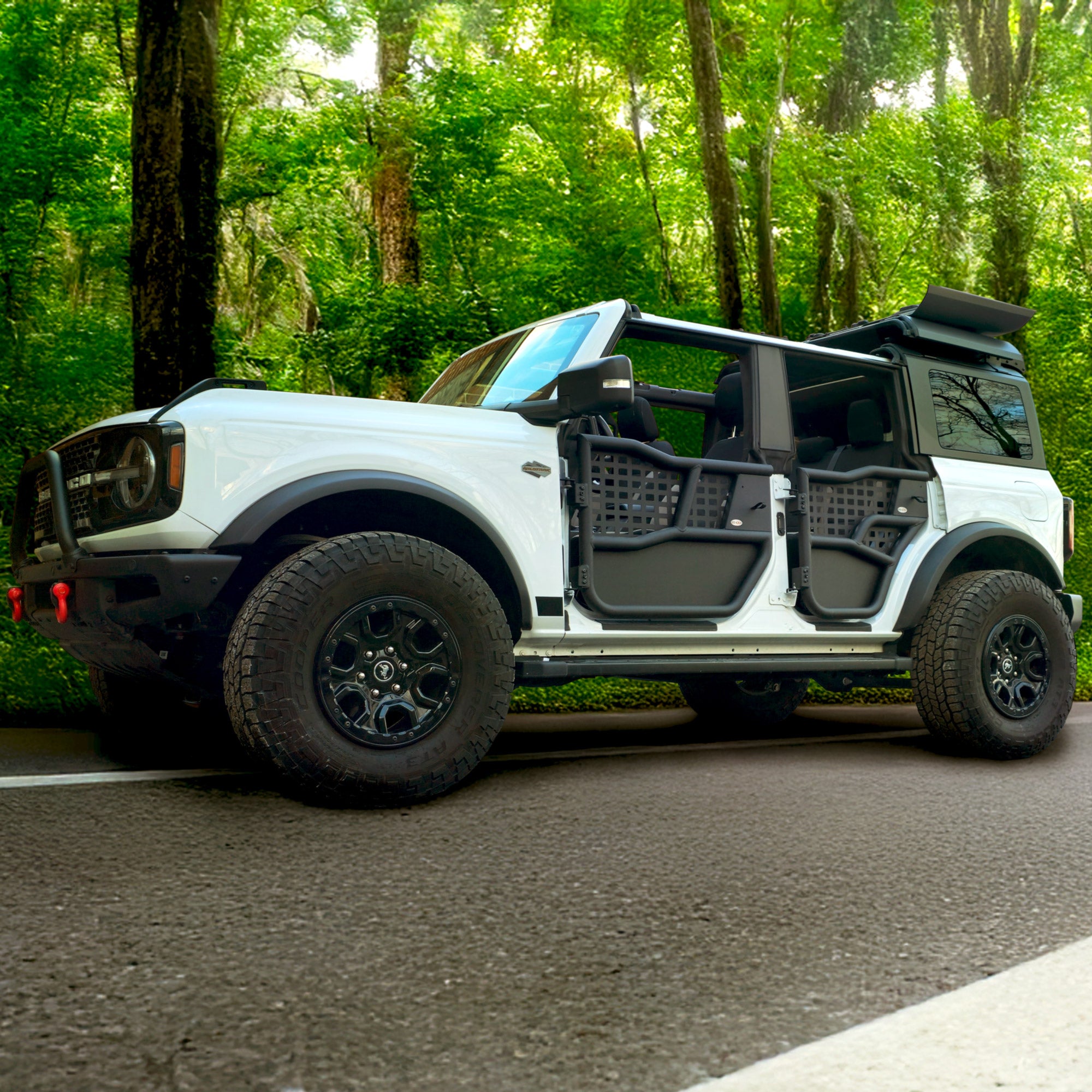 White Ford Bronco equipped with EZ4X4 Alpha Tube Doors, MOLLE panels, an EZ FlipTop, and a Middle Panel Roof Rack Holder.