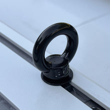 Black t-slot tie-down anchor installed in the roof rack rail of a Ford Bronco.