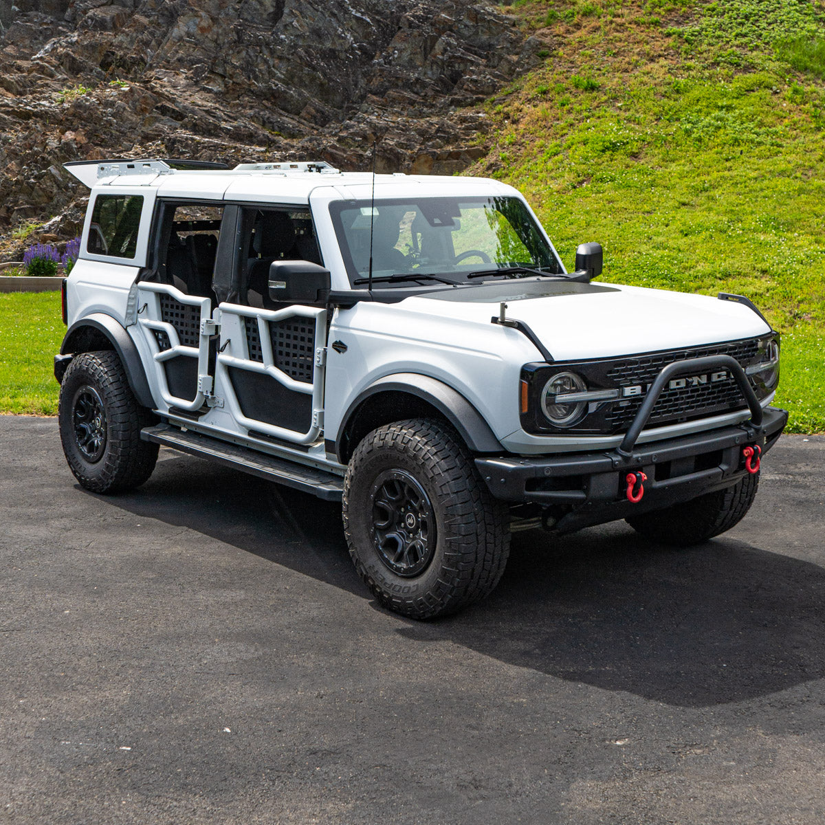 White four-door Ford Bronco with color-matched Alpha Tube Doors and black MOLLE panels.