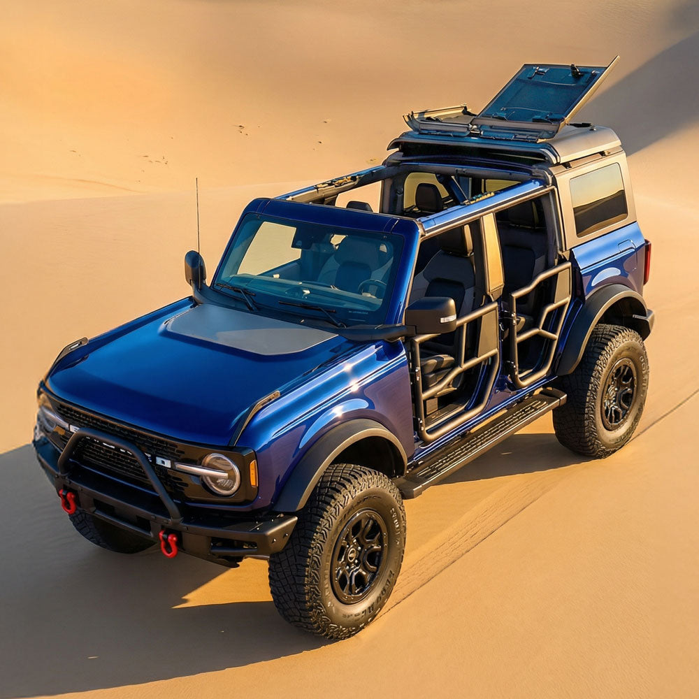 Blue Ford Bronco Driving across sand dunes in a desert
