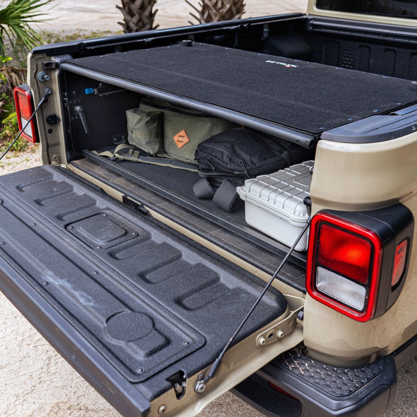 Jeep Gladiator JT Bed Box with tailgate extender and carpeted top, showing organized gear and cargo protection.