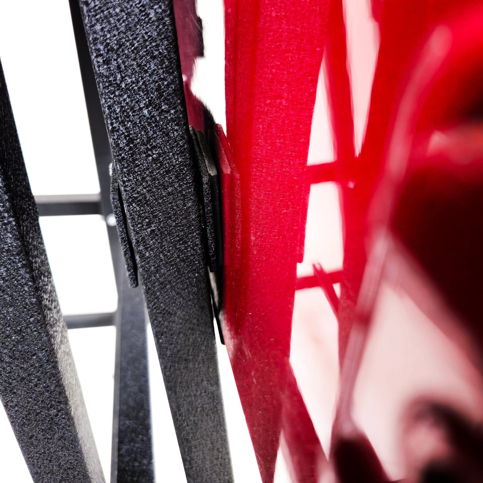 Close-up of red Jeep doors resting on EZ4X4 Door Lift, showing secure, protective storage for vehicle doors.
