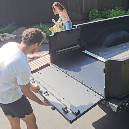 Man setting up EZ Trunk as a truck bed extender, showcasing quick conversion and versatile cargo storage for pickup trucks.