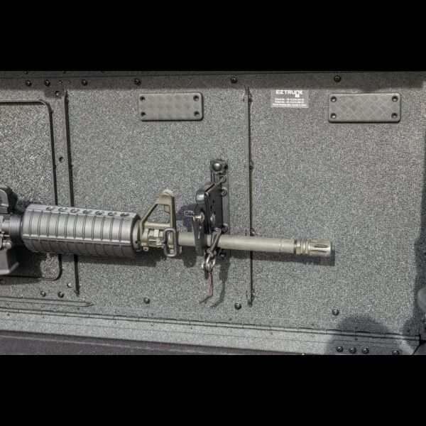 Close-up of EZ4X4 gun mount securing rifle to EZTrunk, showing durable, safe storage for tactical and outdoor gear.