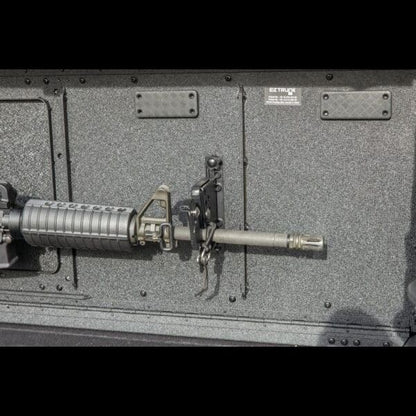Close-up of EZ4X4 gun mount securing rifle to EZTrunk, showing durable, safe storage for tactical and outdoor gear.