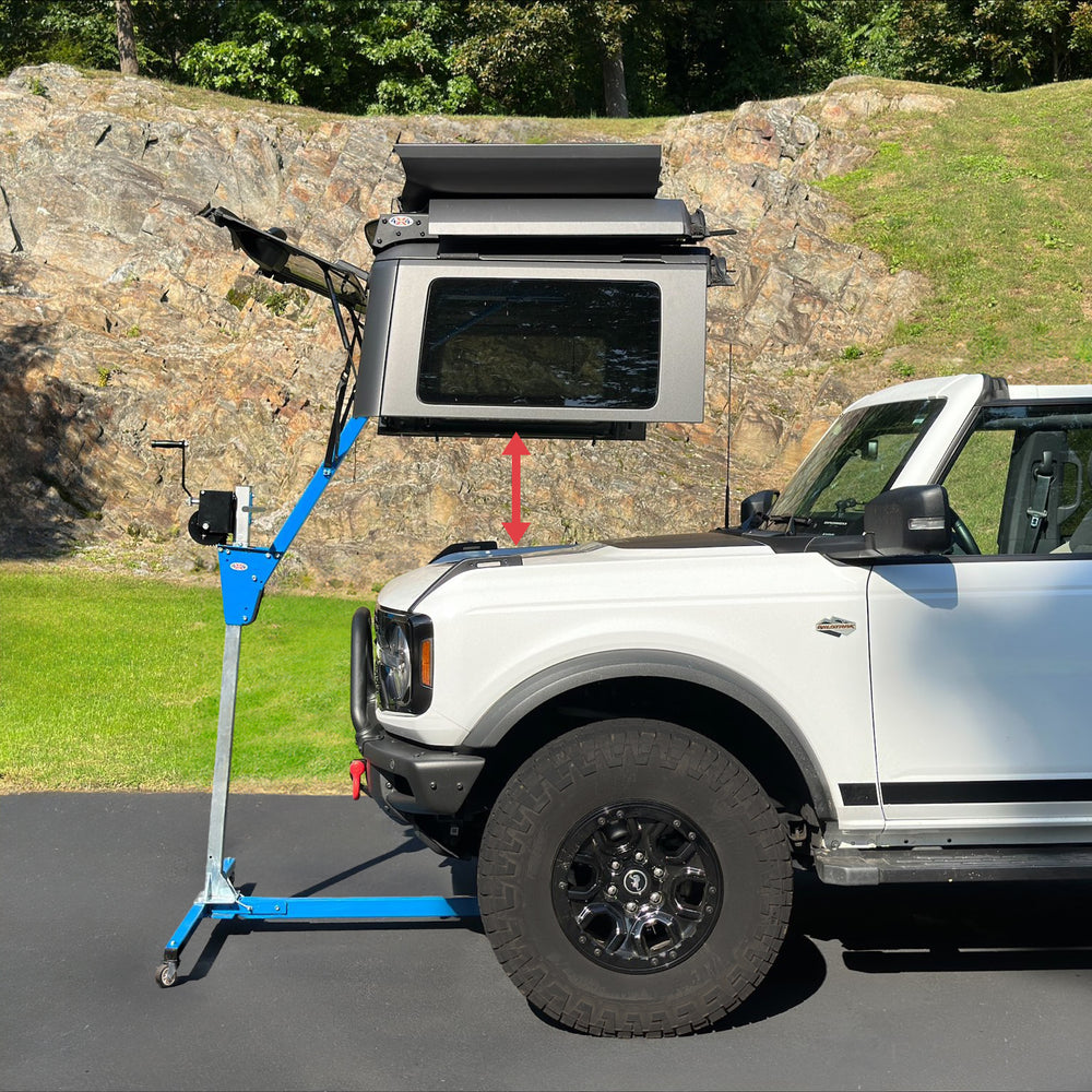 Hardtop stored on lift remover, showing distance between hardtop and front of white Bronco for safe, easy removal.
