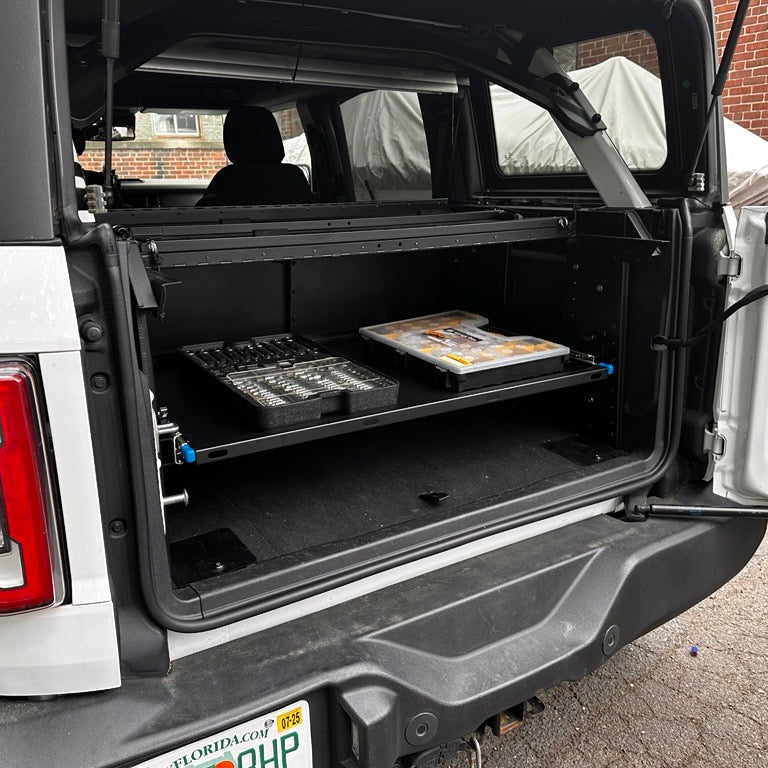 Angled view of EZ4X4 Extreme EZTRUNK with shelf retracted and tools stored in the trunk.