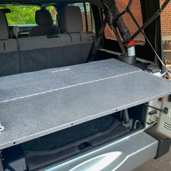 EZ Trunk Tailgate Extension Table open in back of Jeep Wrangler, showing added workspace and secure cargo access.