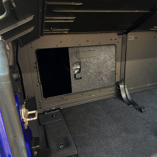 Interior view of EZTrunk with sliding door and lock, showing secure, organized storage for Jeep cargo areas.