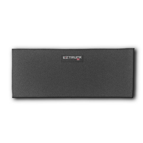 Black rectangular EZTrunk carpet shown on white background, highlighting sleek design and branded aftermarket cargo storage.