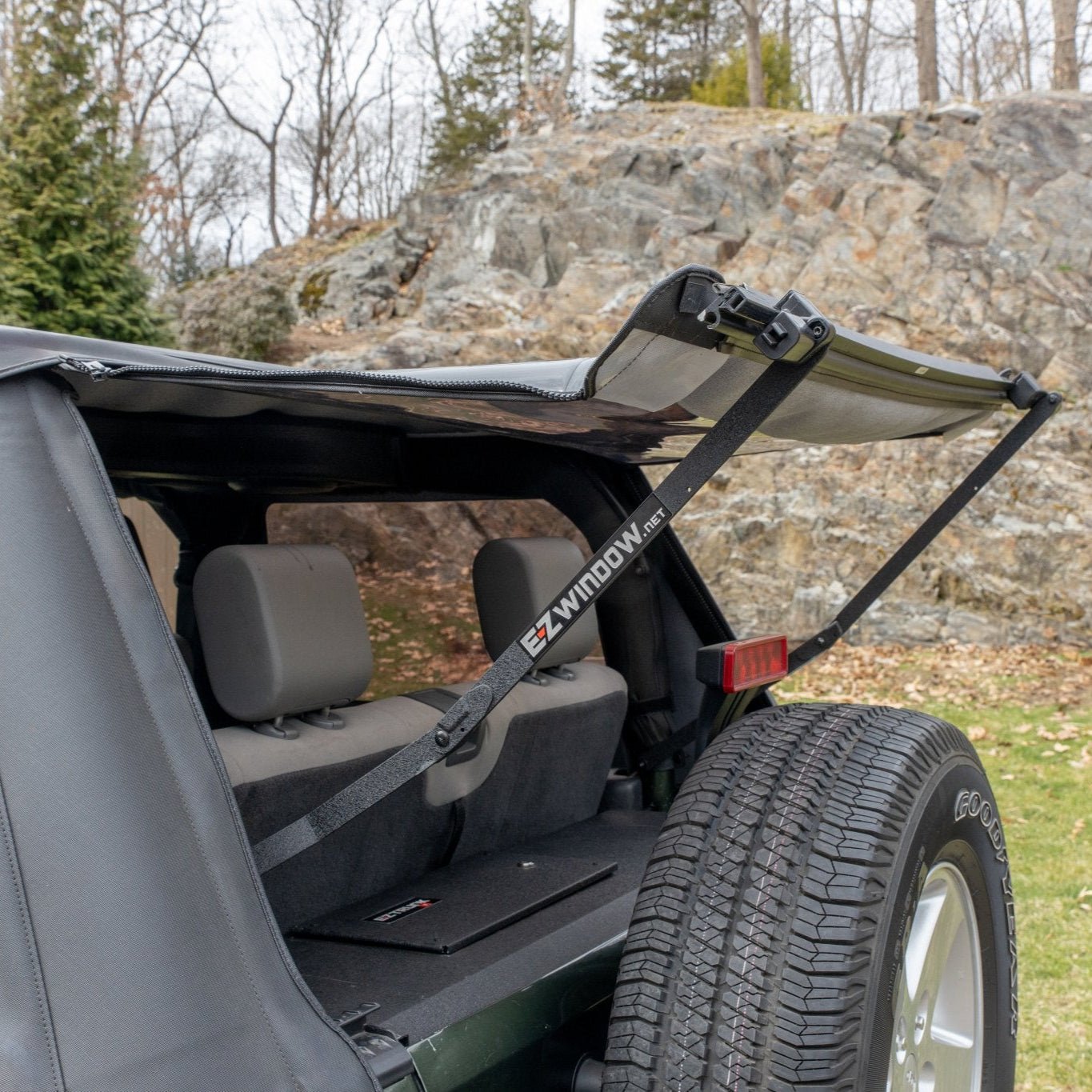 EZ4X4 EZWindow holding up rear window of Jeep soft top, showcasing easy rear access and improved ventilation.