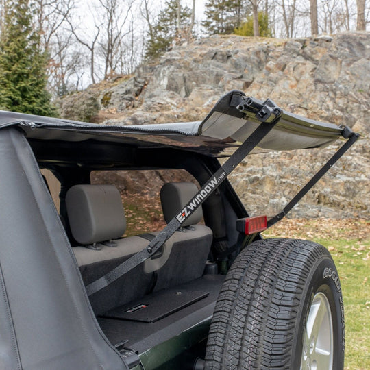 EZ4X4 EZWindow holding up rear window of Jeep soft top, showcasing easy rear access and improved ventilation.