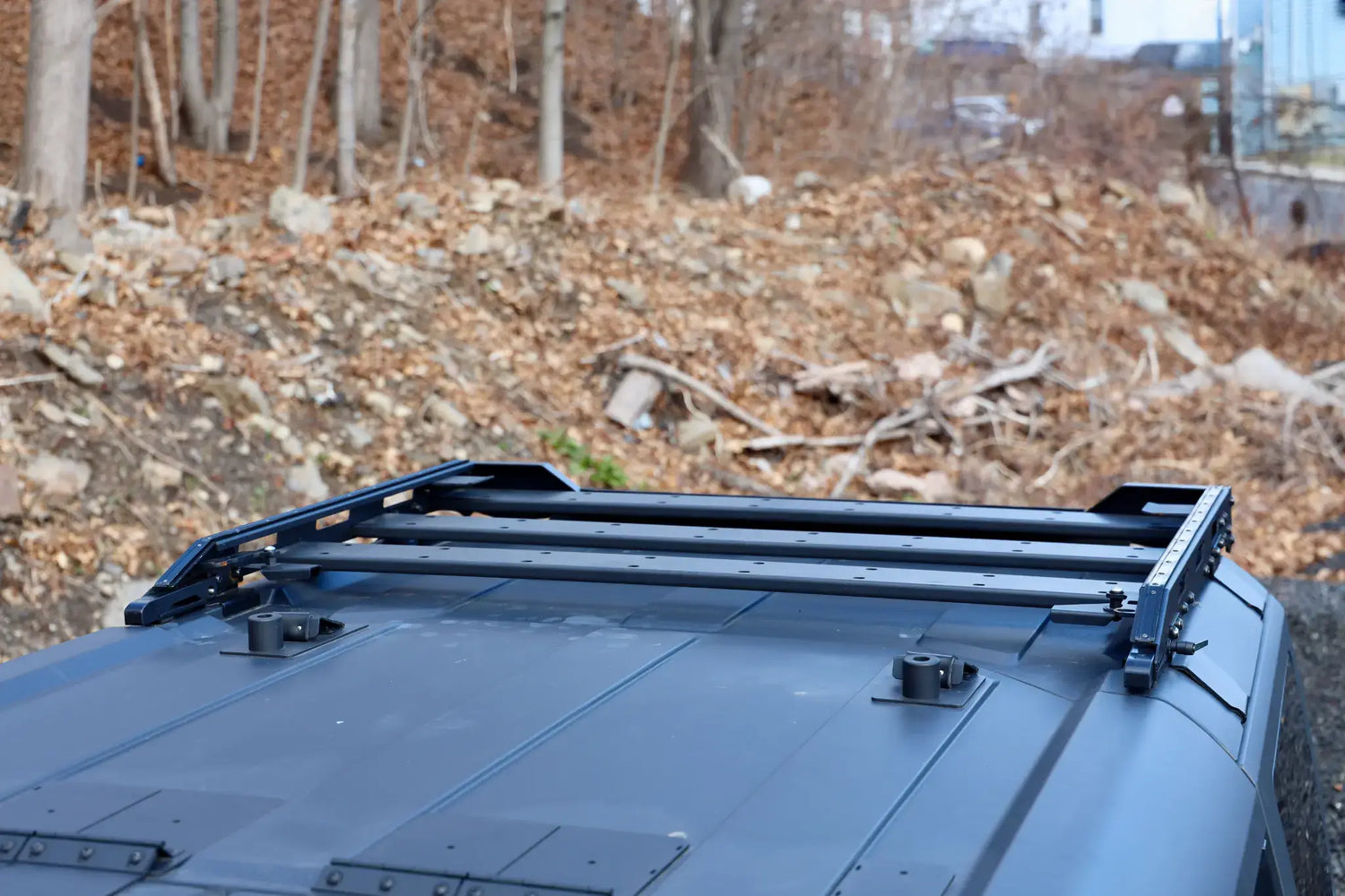 Close-up of the EZ4X4 Middle Panel Roof Rack Holder mounted on a black Ford Bronco hard top.
