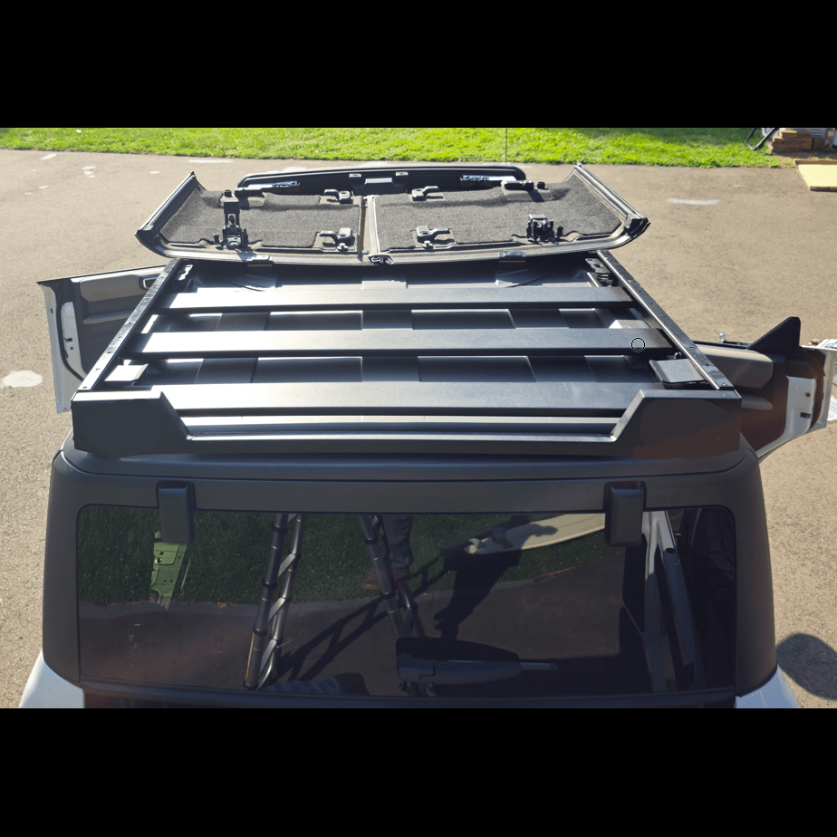 Close-up image of a roof rack securely installed on a Ford Bronco, showing mounting brackets and sturdy construction details.