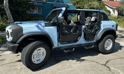 Light blue Ford Bronco with aluminum Alpha doors and all-weather panels, built for durability.