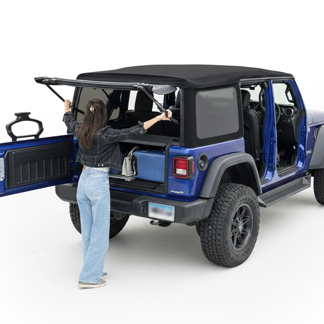 Woman using EZ4X4 EZWindow to prop open the rear soft top window on a blue Jeep Wrangler.