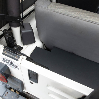 Overhead left side of EZ4X4 EZTrunk installed in white Jeep TJ Wrangler with cargo door closed, showing secure storage setup.