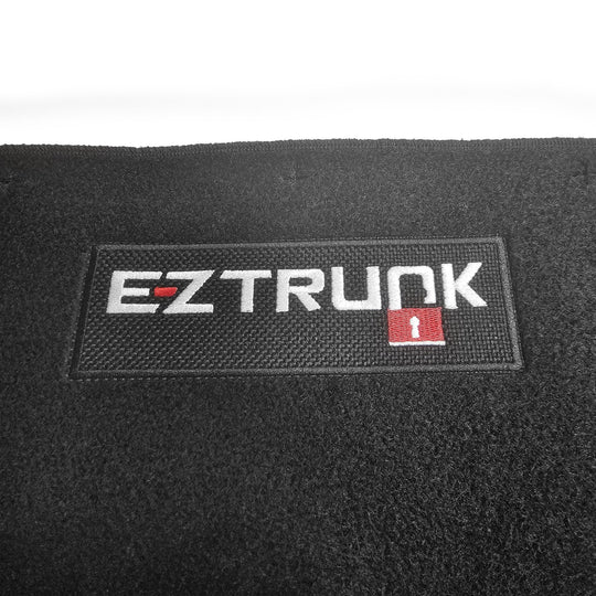 Black carpet mat with 'EZ Trunk' logo shown on white background.
