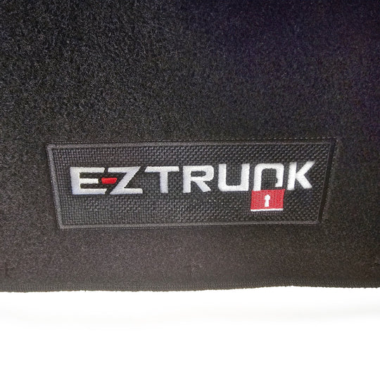 Black carpet mat with 'EZ Trunk' logo shown on white background.