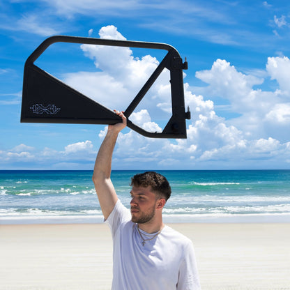 Man lifting black Phantom aluminum door overhead, showcasing lightweight, removable design and rugged durability.