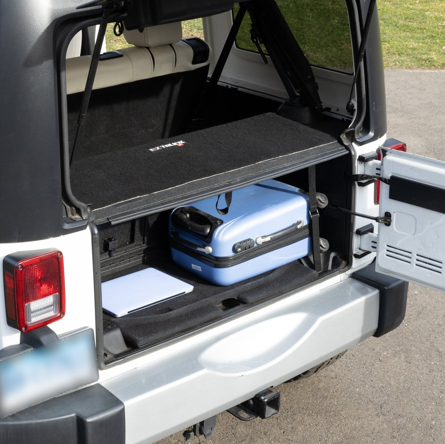 EZTrunk 4-door tailgate carpet installed with gear, showing spacious storage and custom-fit cargo protection.