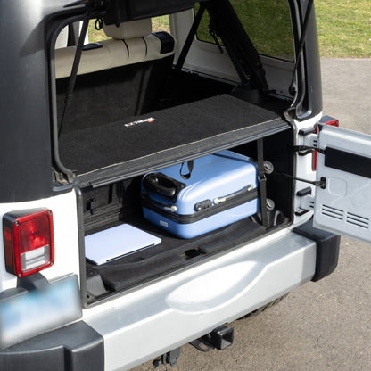 EZTrunk 4-door tailgate carpet installed with gear, showing spacious storage and custom-fit cargo protection.