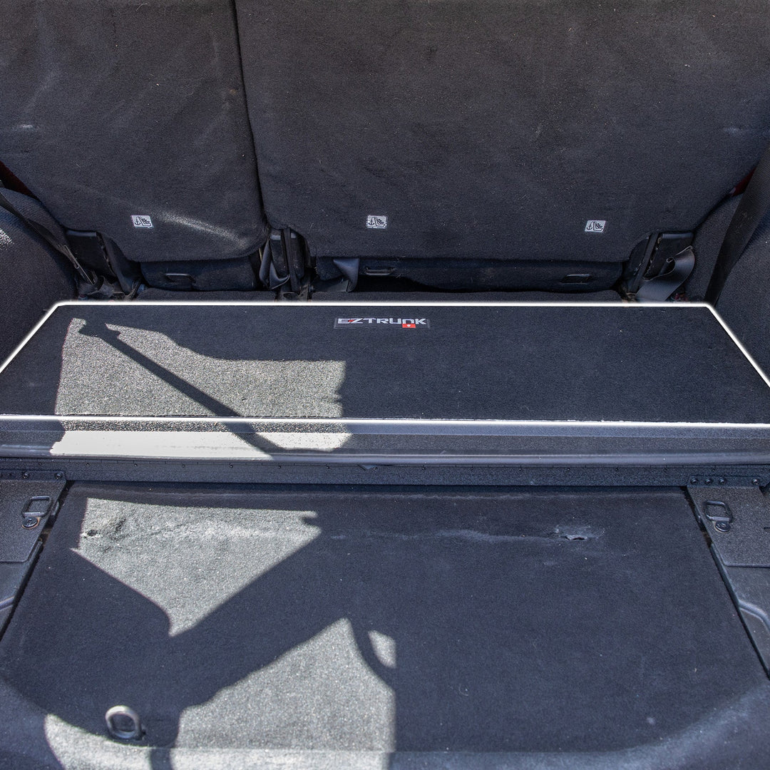 Black carpet mat with 'EZ Trunk' logo installed.